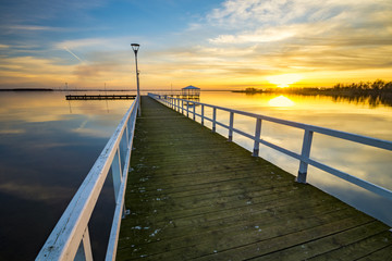 Obraz premium wooden pier on the lake, sunset