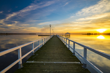 wooden pier on the lake, sunset