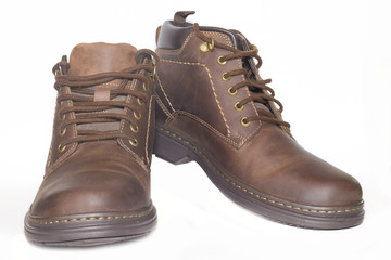 Brown man's leather boots isolated on white background.