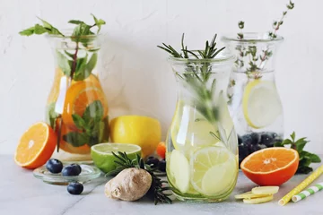 Foto auf Alu-Dibond Infused water with citrus fruits and ginger.Detox beverages in glass jar and ingredients. Selective focus © losangela