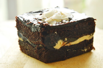 chocolate butter cake topping slicing white chocolate on wooden chop plate