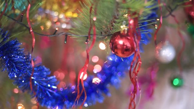 New Year Christmas. Blurred background with tinsel, tinsel and Christmas balls. Camera movement on rails.