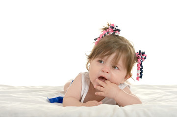 Baby girl lying on  blanket
