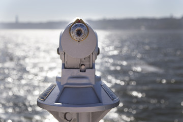 old monocular telescope on seaside