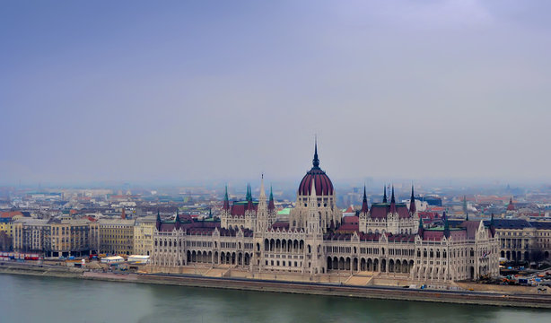 View on the Parliament of Budapest, river Danube and nearby houses on a winter day