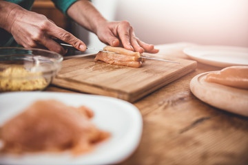 Woman cutting chicken meet