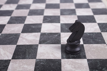 black wooden knight on chessboard