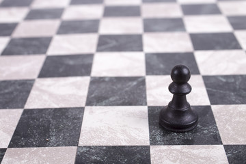 black wooden pawn on chessboard