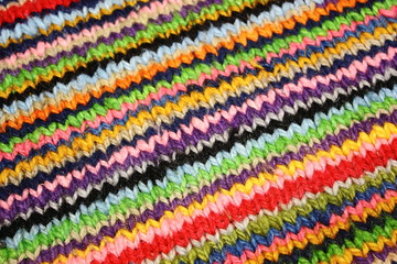 Fototapeta na wymiar striped diferent colour wool lines Knitting with v stitch on a Peruvian jumper 
