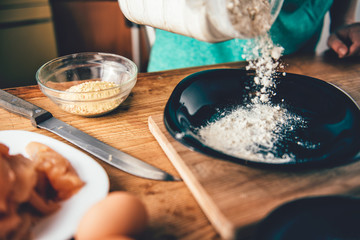 Woman Pouring breadcrumbs