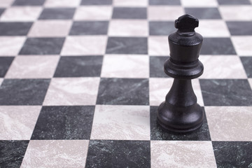 black wooden king on chessboard