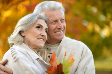  mature couple posing outdoors 