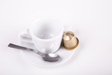 coffee cup with capsule and spoon