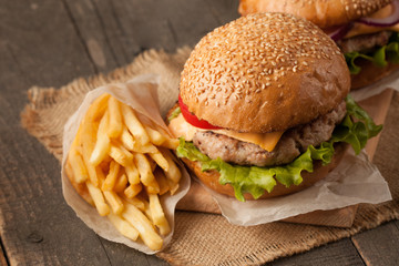 Close-up photo of home made hamburger with beer made of beef, onion, tomato, lettuce, cheese and...