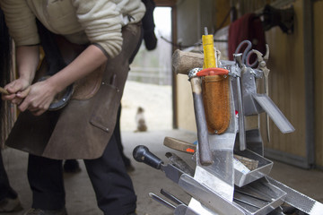 Farrier's tools and female farrier working