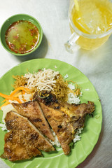 Vietnamese broken rice with grilled pork chop, one of the popular breakfast food in Vietnam.