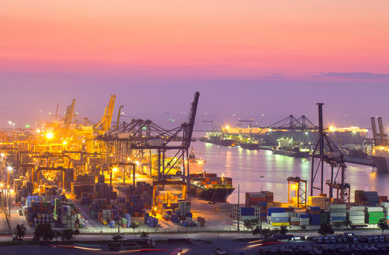 Container Cargo freight ship with working crane bridge in shipyard at dusk for Logistic Import Export background