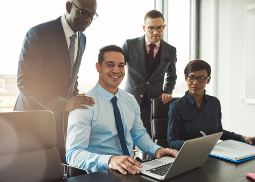 Group of four young business people in office