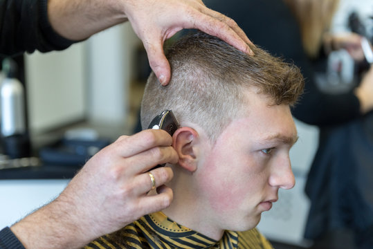 young man on a haircut in the barber shop