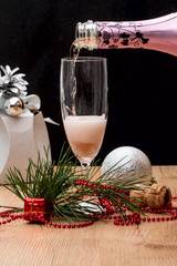 Filling wine glass pink sparkling drink