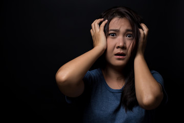 Shocked woman on isolated black background