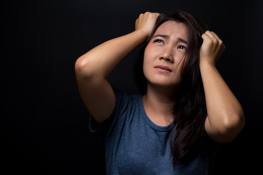 Angry woman on isolated black background