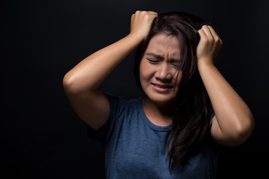 Angry woman on isolated black background