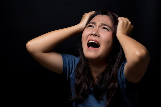 Screaming woman on black background