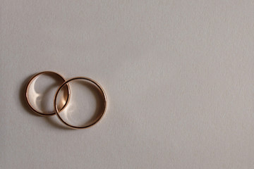Wedding accessories. Two golden rings for wedding invitation background. Engagement rings ideal for...