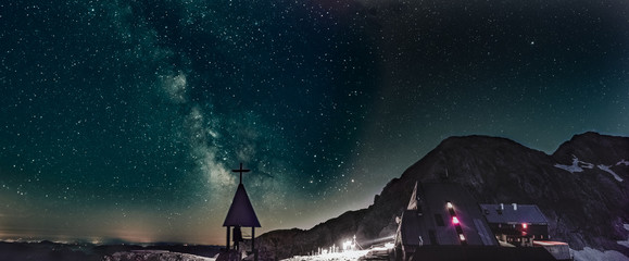 night panorama of milky way over the church under the Triglav peak