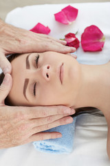 Obraz na płótnie Canvas Beautiful young girl having face massage in spa salon.