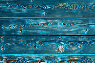 Image of bumpy wooden background painted with blue paint