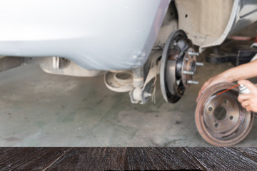 mechanic spray chemical to clean brake (blur image) with selecte