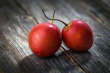 Fresh fruit tamarillo on wooden background