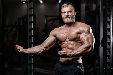 Naklejka na ściany i meble brutal muscular man with beard unshaven fitness model healthcare