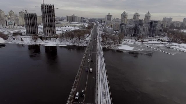 City Traffic on the bridge, it's snowing. Shooting from the air, 4k video