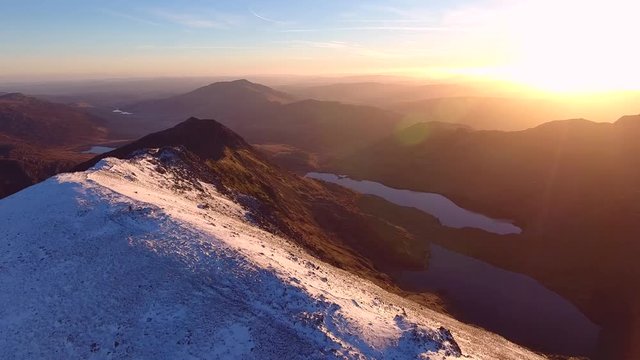 Panning aerial shot of a spectacular sunrise over Snowdonia in Wales, UK.