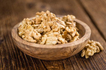 Cracked Walnuts on wooden background (selective focus)