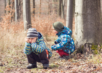 Naklejka premium Tired or bored child in forest