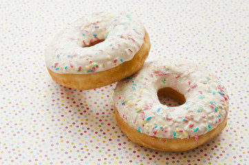 glazed donuts decorated with colorful sprinkles