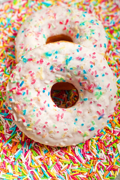 sugar glazed donut doughnut decorated with colorful sprinkles
