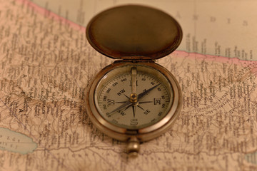 Old compass on the background of old maps