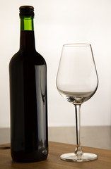 bottle of wine and one glass