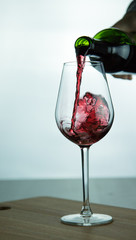 falling red wine in glass
