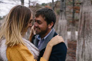 Fototapeta premium happy couple outdoor. hugging and kissing man and woman in park