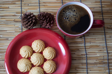 Hot coffee and homemade cookies on wooden background.