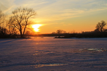 Sunset over the frozen river Dnieper on winter