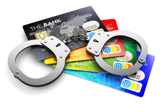 Bank credit cards and handcuffs isolated on white