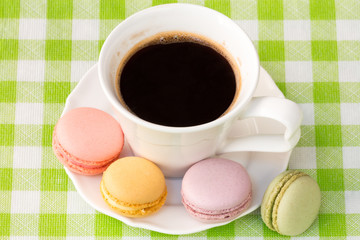 Cup of coffee with french macaroons