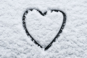 heart shape in snow on car window -